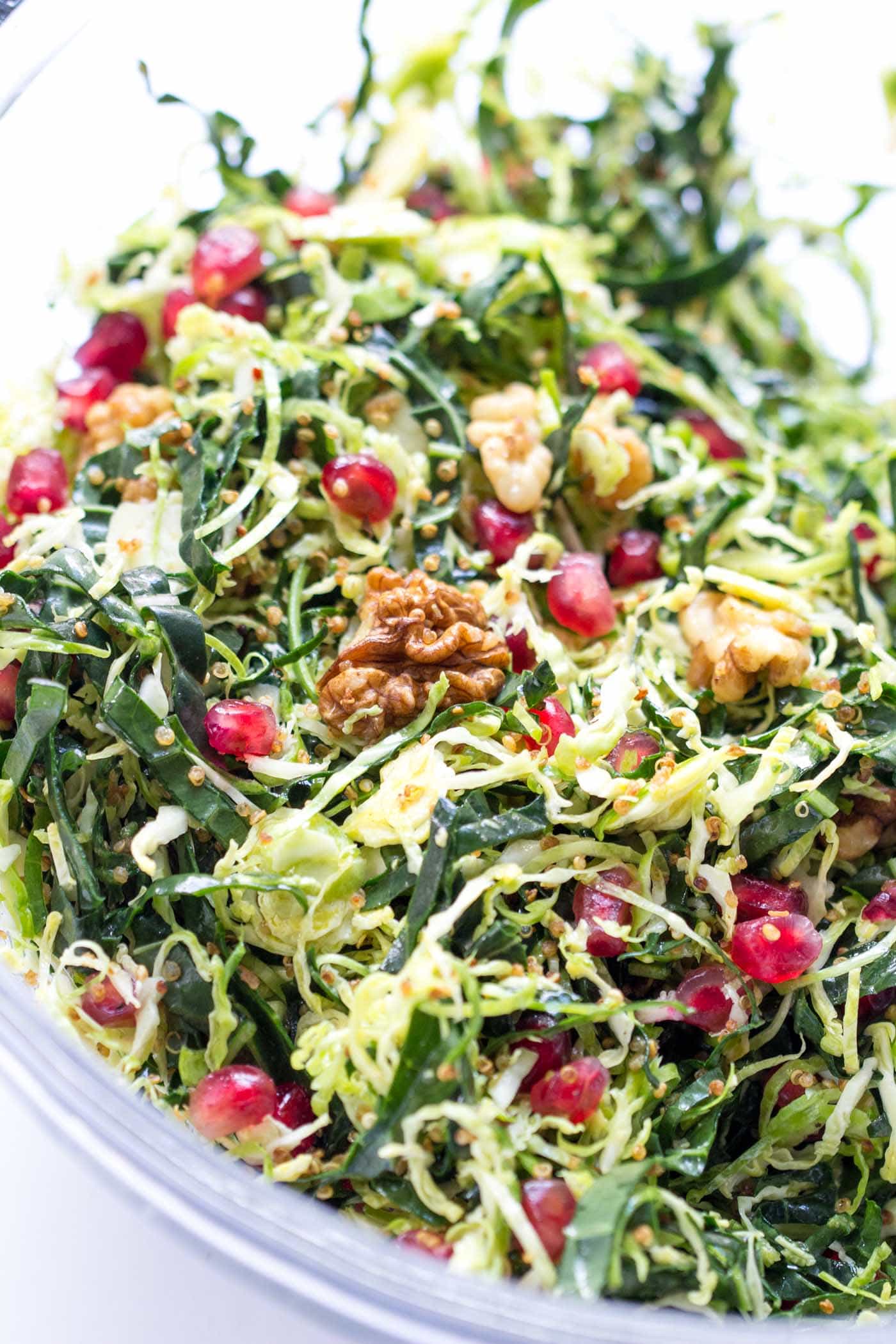 A healthy holiday salad with shredded brussels sprouts, kale, quinoa, walnuts and pomegranates -- it looks so festive and delicious!