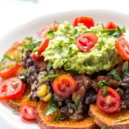 Sweet Potato Quinoa Nachos -- made with baked sweet potatoes, a black bean-quinoa mixture, salsa and topped with guac!