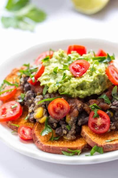 Sweet Potato Quinoa Nachos -- made with baked sweet potatoes, a black bean-quinoa mixture, salsa and topped with guac!