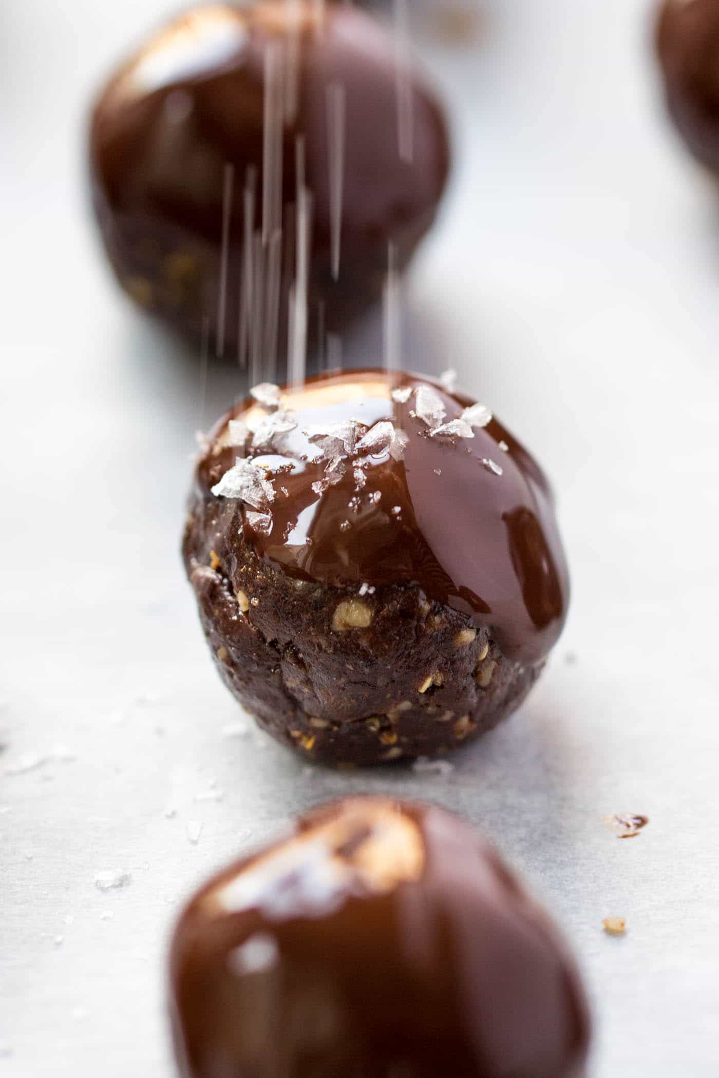 These dark chocolate QUINOA ENERGY BALLS are coated with a layer of melted chocolate and then sprinkled with sea salt -- PERFECTION! {vegan + gf}