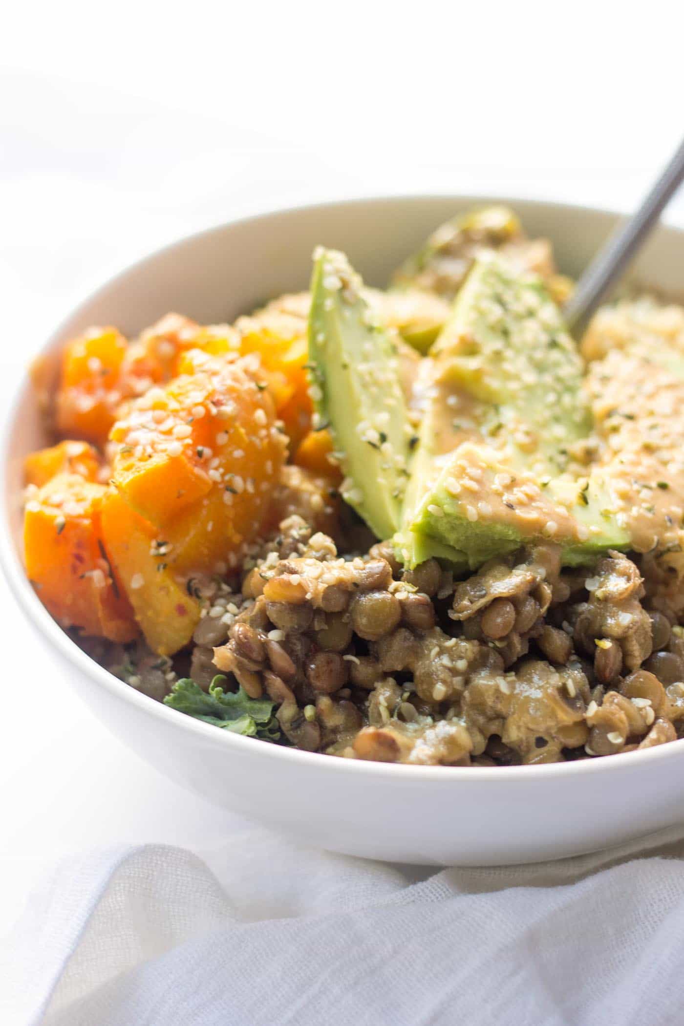 Cozy Quinoa Buddha Bowls with kale, lentils, roasted veggies and avocado -- they make the simplest plant-based meal ever!