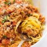Spaghetti squash swirled around a fork in a bowl of spaghetti squash bolognese.