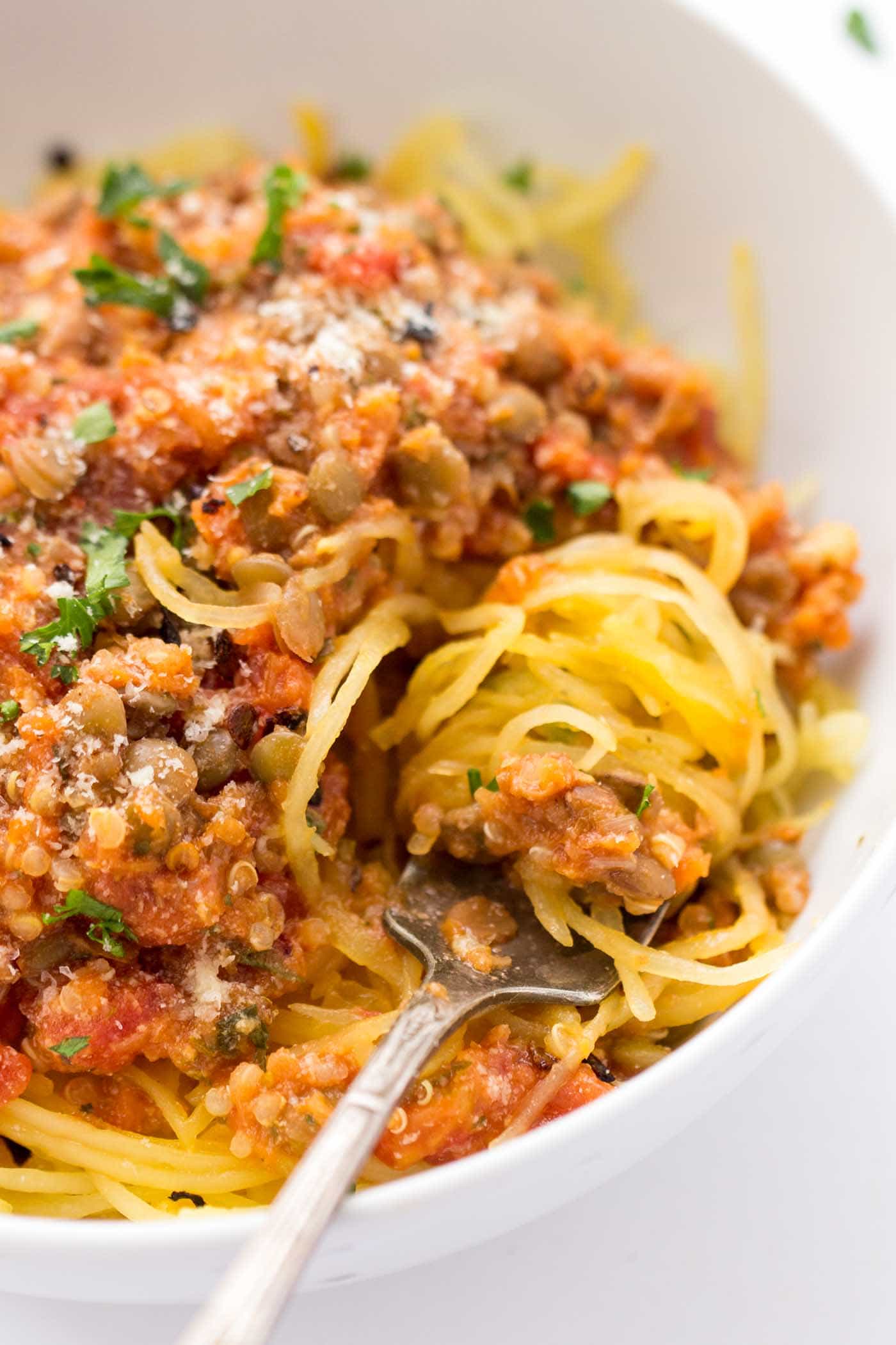 Spaghetti squash swirled around a fork in a bowl of spaghetti squash bolognese.