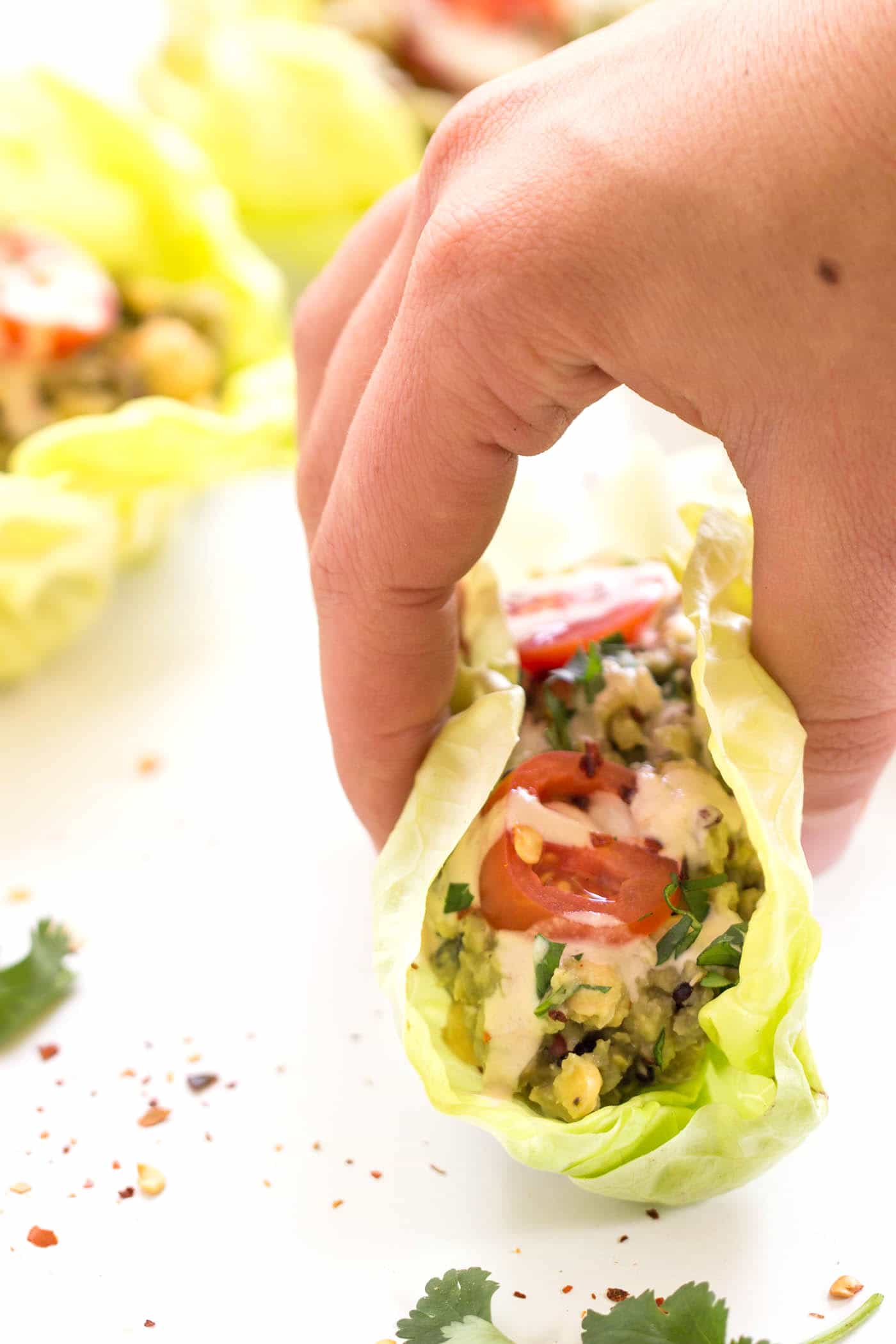 Grab one of these quinoa lettuce wraps for lunch today! Filled with a HEALTHY + VEGAN smashed chickpea salad, you get tons of protein, fiber and healthy fats.