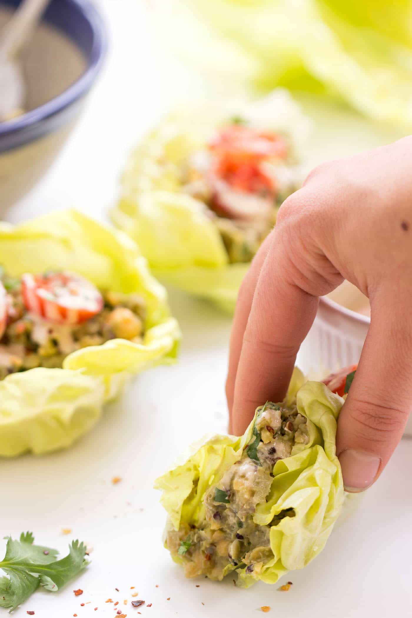 Grab one of these quinoa lettuce wraps for lunch today! Filled with a HEALTHY + VEGAN smashed chickpea salad, you get tons of protein, fiber and healthy fats.