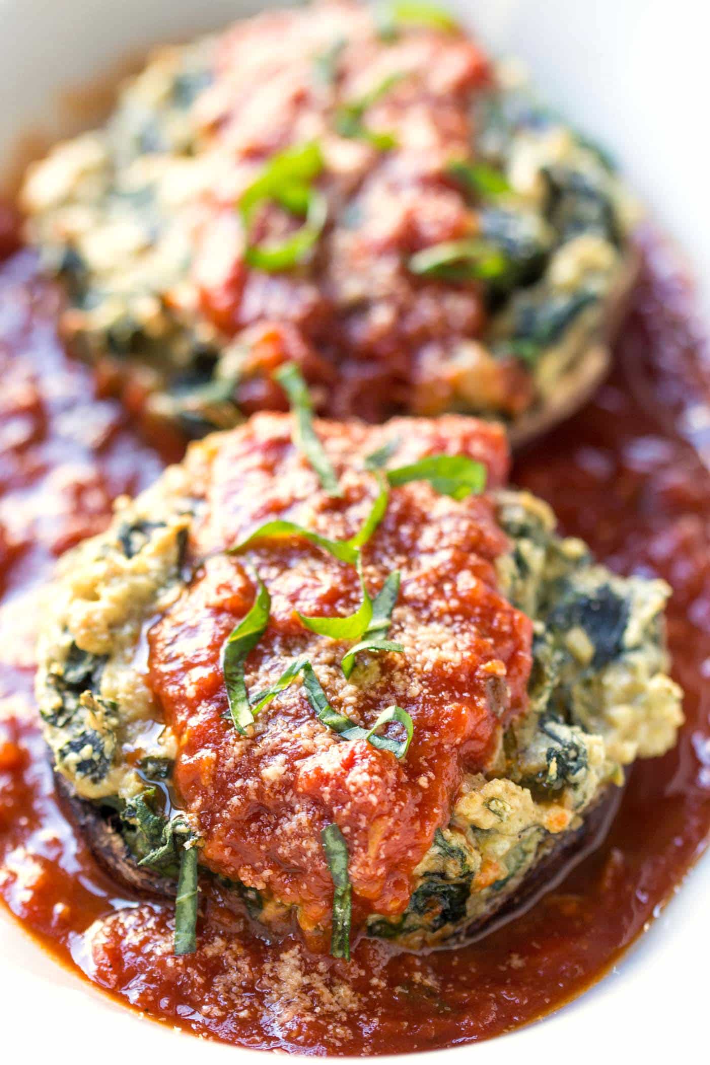 Vegan Ricotta + Quinoa Stuffed Mushrooms with spinach, garlic and tomato sauce -- the perfect meatless meal!