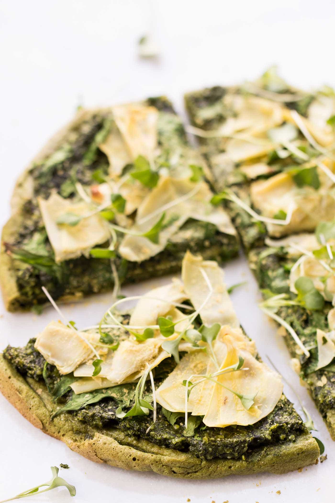 VEGAN QUINOA PIZZA...topped with pesto, spinach + artichokes, then sprinkled with nutritional yeast for a nice cheesy flavor! [gluten-free]