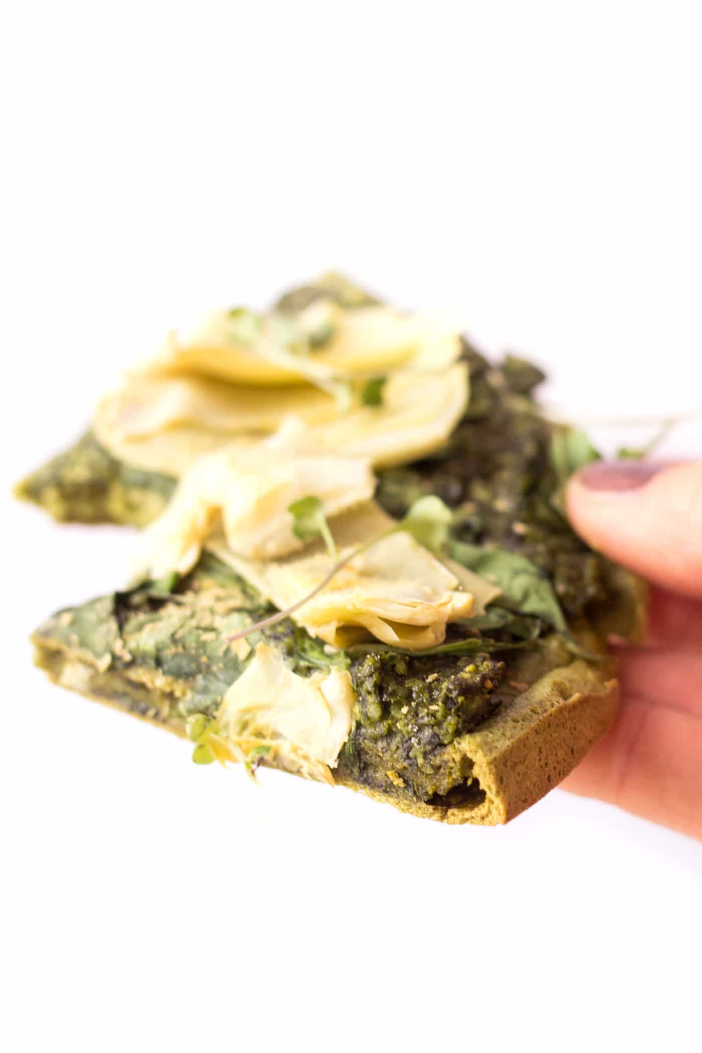 This is the PERFECT slice of pizza --> quinoa pizza crust topped with vegan pesto, spinach + artichokes. Oh my heaven!