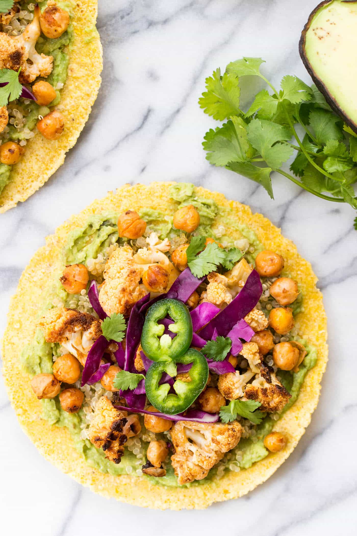 Buffalo Cauliflower + Quinoa Tacos -- a quick and easy vegan taco recipe that boasts a ton of bold flavor and lots of nutrients!