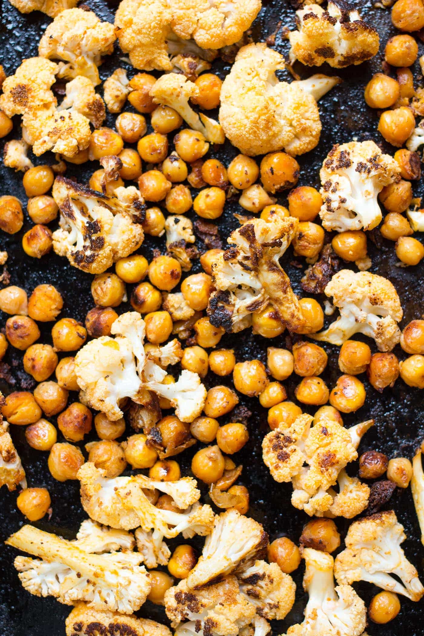 This roasted Buffalo Cauliflower + Chickpea mixture makes the most AMAZING vegan taco filling ever!