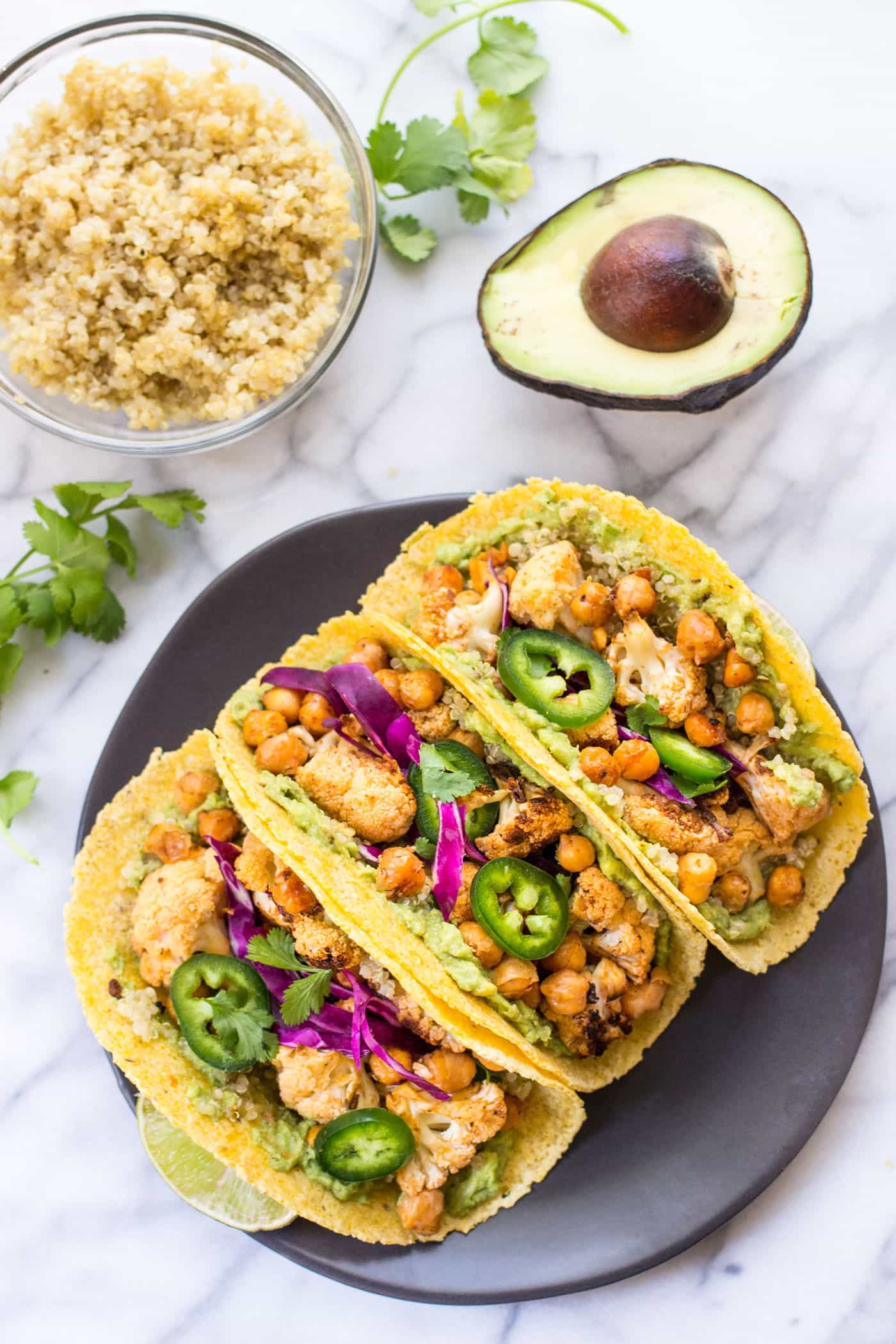 BUFFALO CAULIFLOWER + QUINOA TACOS -- a healthy meatless meal that is packed with nutrition and TONS of flavor!
