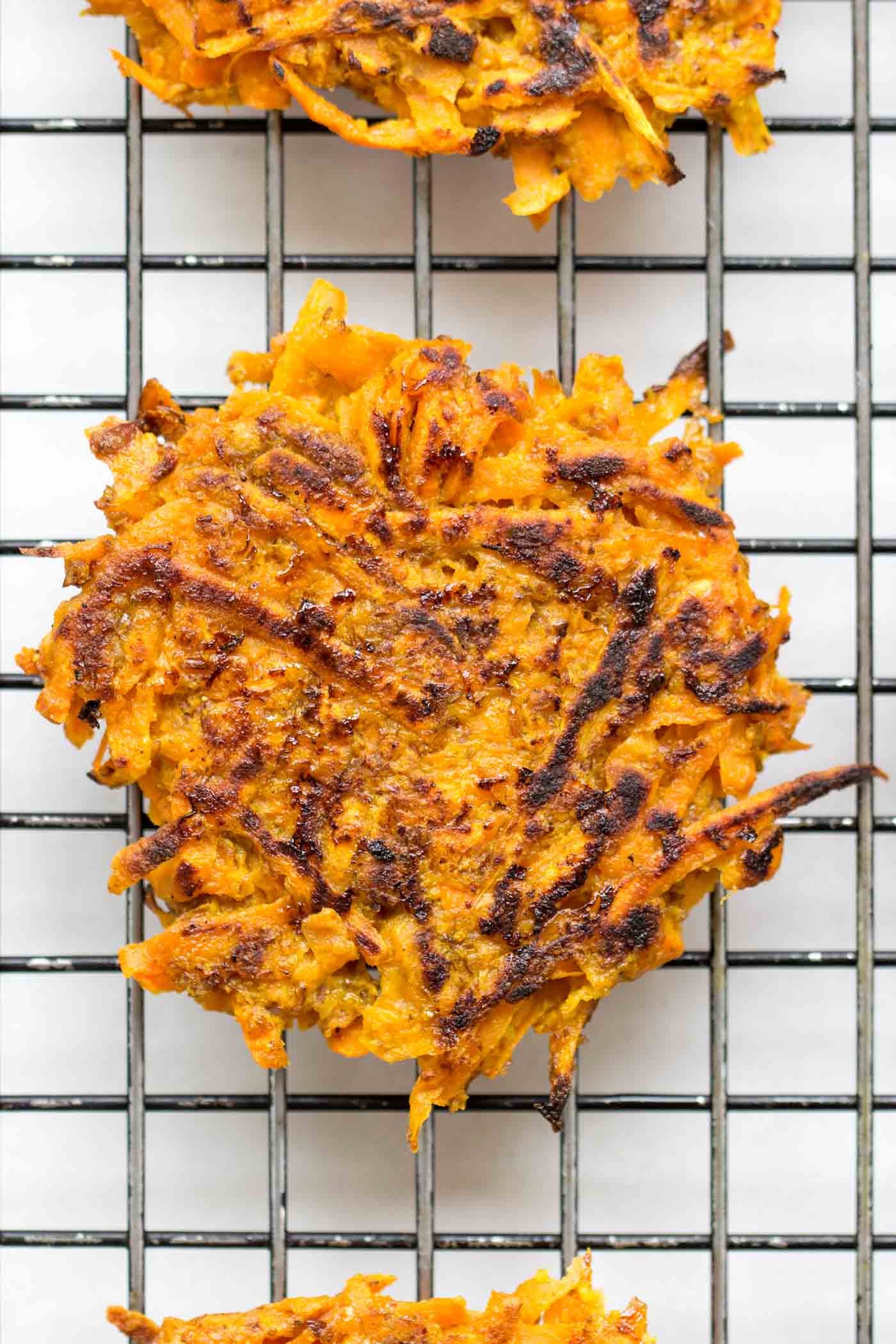 Light, flavorful and perfectly CRISP! These curried carrot + sweet potato fritters are also HEALTHY!