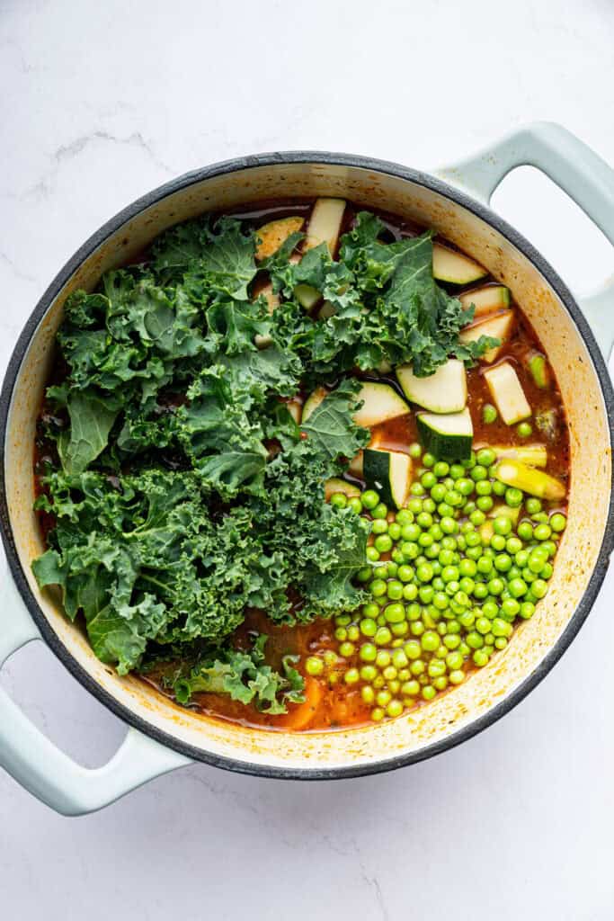 Vegetables added to pot of minestrone soup