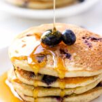 Love these fluffy QUINOA PANCAKES studded with fresh blueberries and drizzled in warm maple syrup. They're the ULTIMATE breakfast treat!