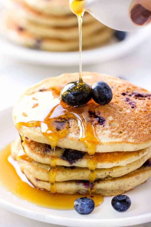 Love these fluffy QUINOA PANCAKES studded with fresh blueberries and drizzled in warm maple syrup. They're the ULTIMATE breakfast treat!