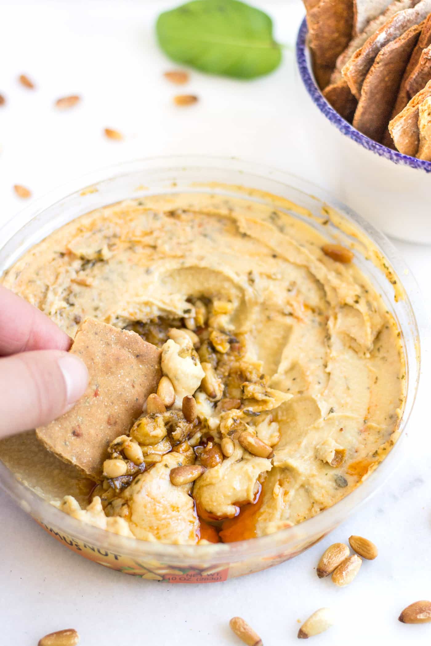 SIMPLE QUINOA CRACKERS dipped in a roasted pine nut hummus...the perfect snack or appetizer!