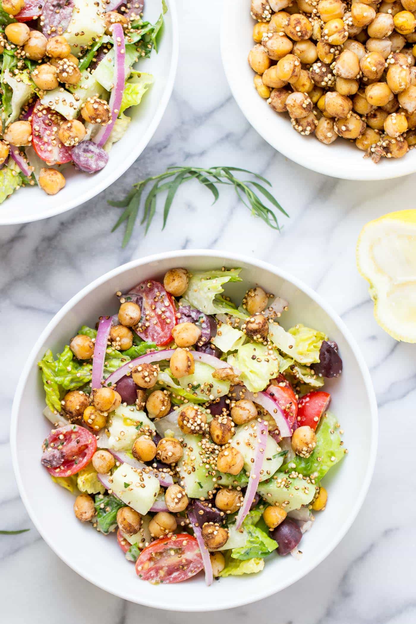 An AMAZING vegan chopped salad with tons of veggies, warm chickpeas and a tarragon tahini dressing!