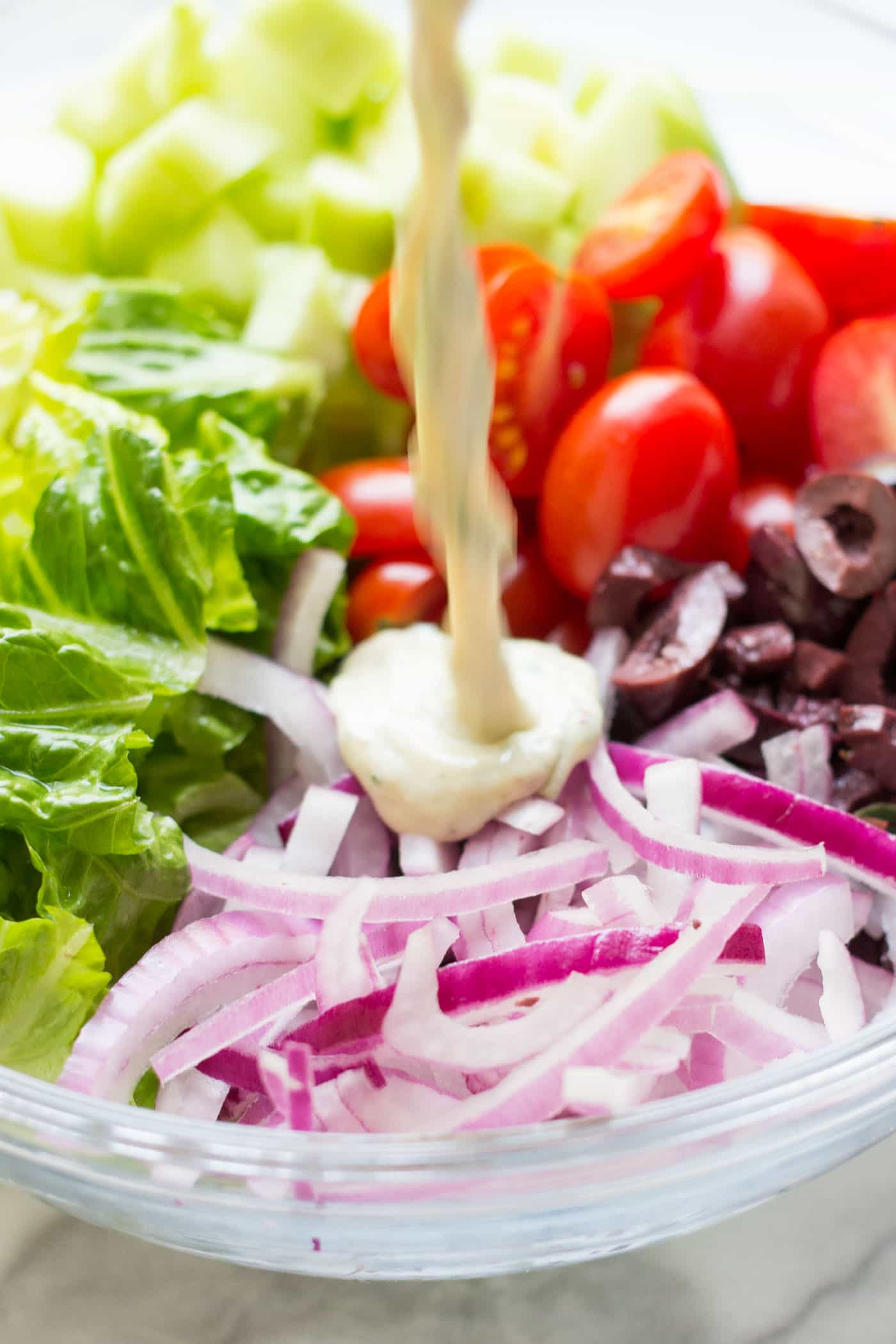 An AMAZING vegan chopped salad with tons of veggies, warm chickpeas and a tarragon tahini dressing!