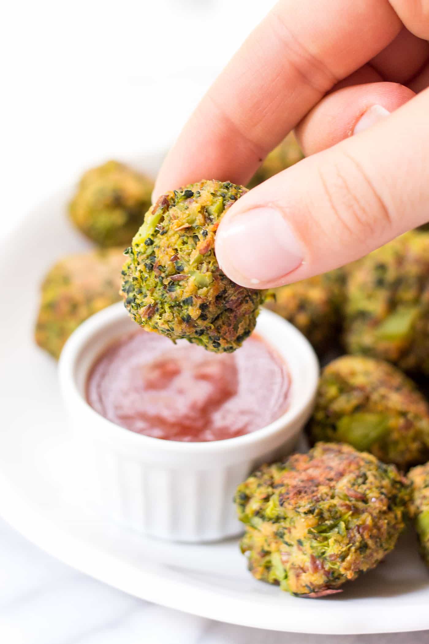 vegan quinoa broccoli tots dipped in ketchup