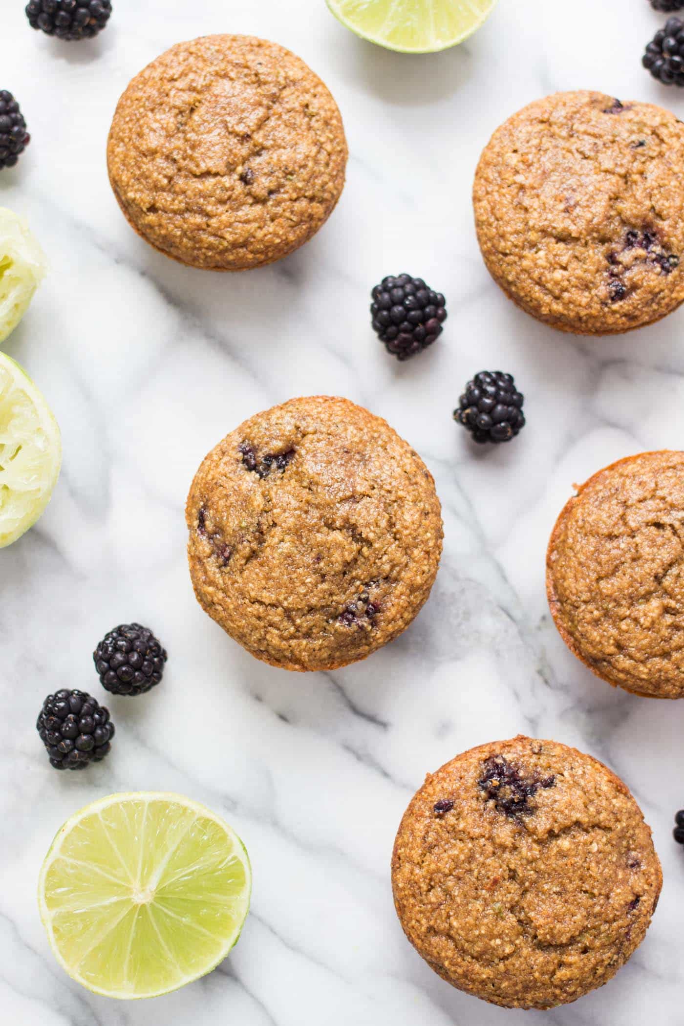 Blackberry Lime Oatmeal Muffins topped with a creamy coconut butter glaze! Naturally gluten-free, without any dairy, oils or eggs!