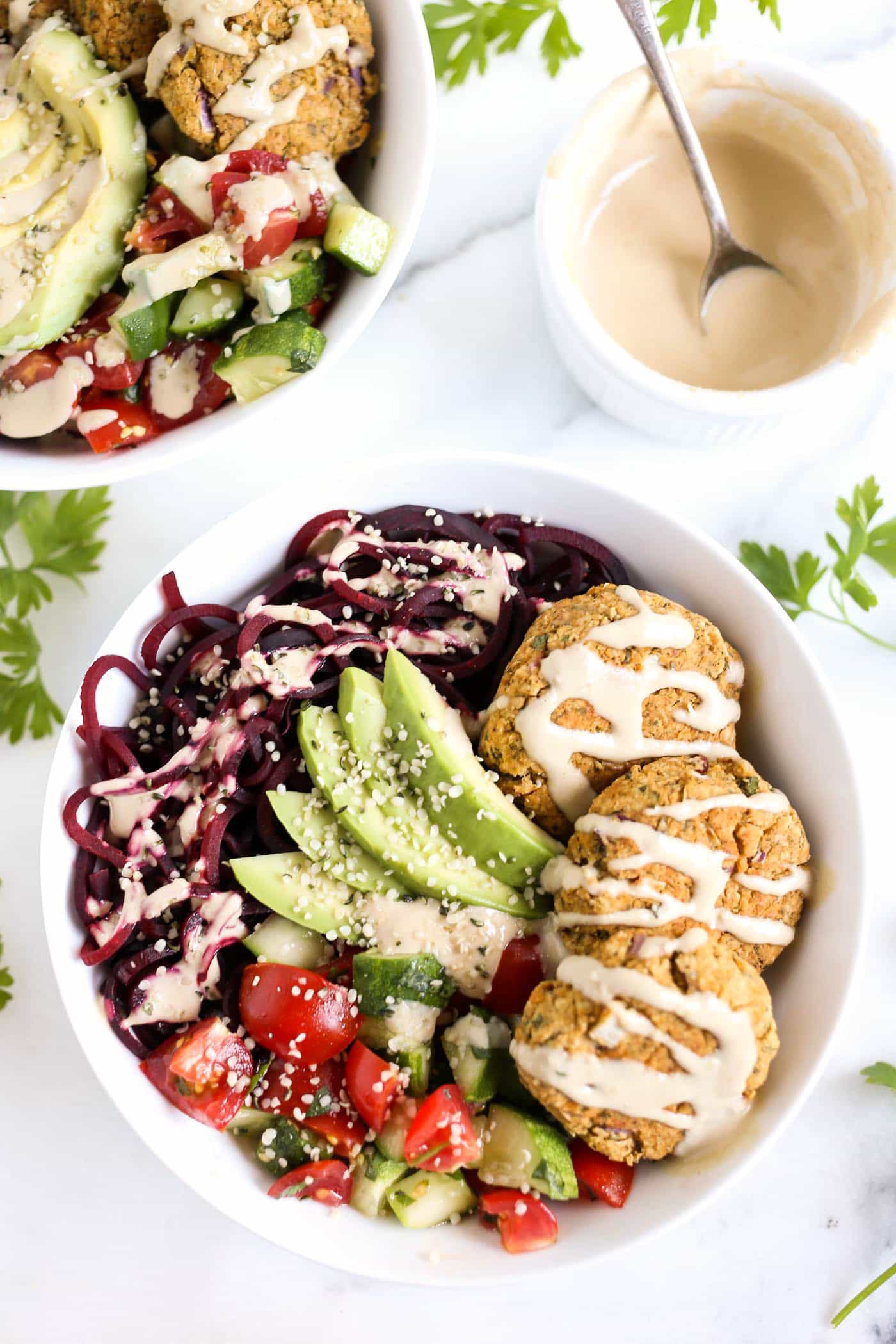 VEGETARIAN FALAFEL BOWLS with beet noodles. cucumbers, tomatoes and a creamy tahini dressing! 