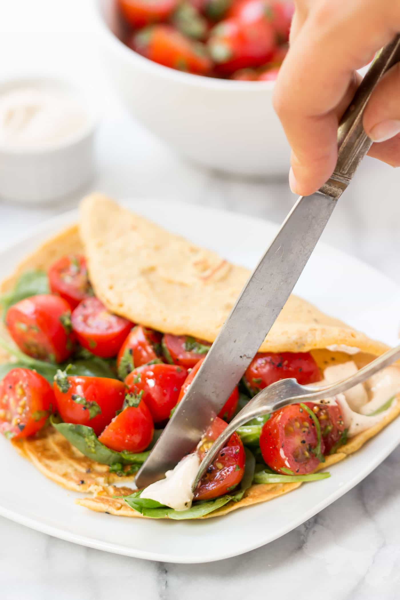 Savory Chickpea Pancakes served with a fresh tomato-cilantro salad and spinach!