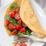 Savory Chickpea Pancakes served with a fresh tomato-cilantro salad and spinach!