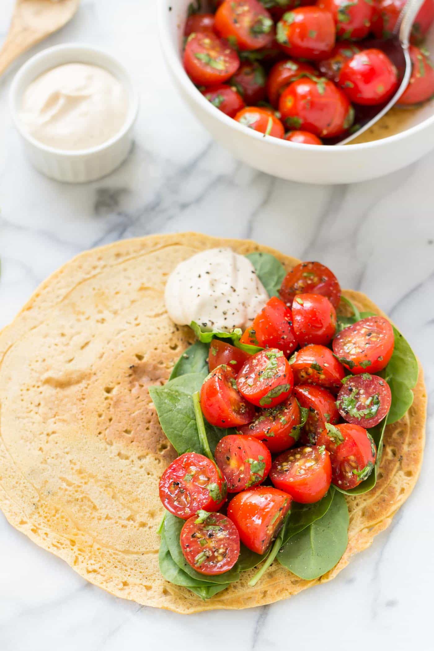 Savory Chickpea Pancakes served with a fresh tomato-cilantro salad and spinach!