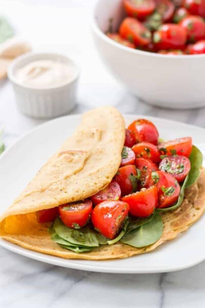 Savory Chickpea Pancakes served with a fresh tomato-cilantro salad and spinach!