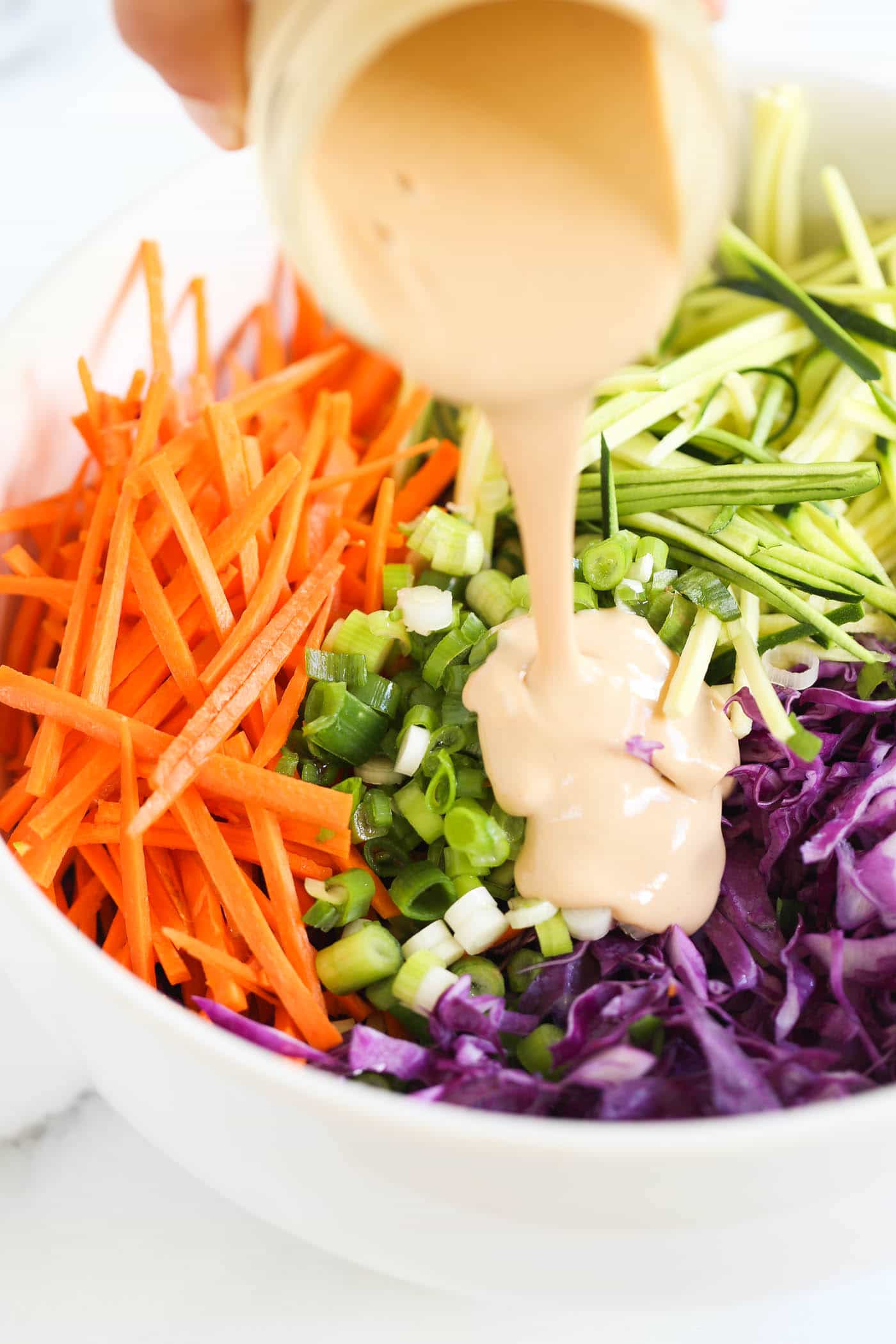 this MAYO-FREE coleslaw recipe uses tahini to make it ultra creamy and maple syrup to give it a bit of sweetness! 