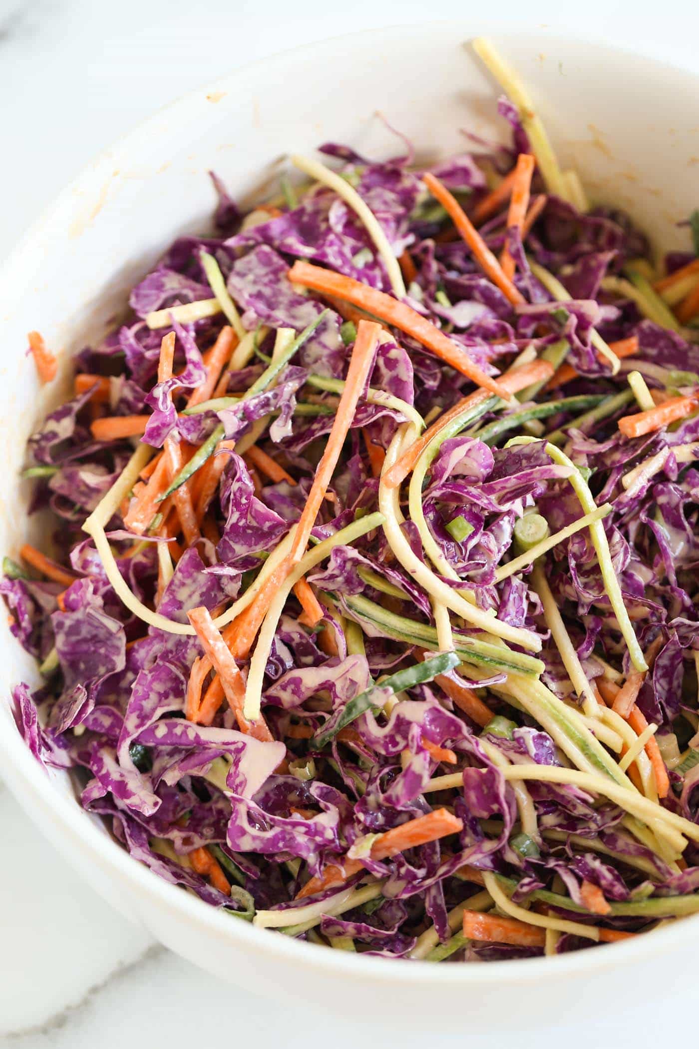 this MAYO-FREE coleslaw recipe uses tahini to make it ultra creamy and maple syrup to give it a bit of sweetness! 