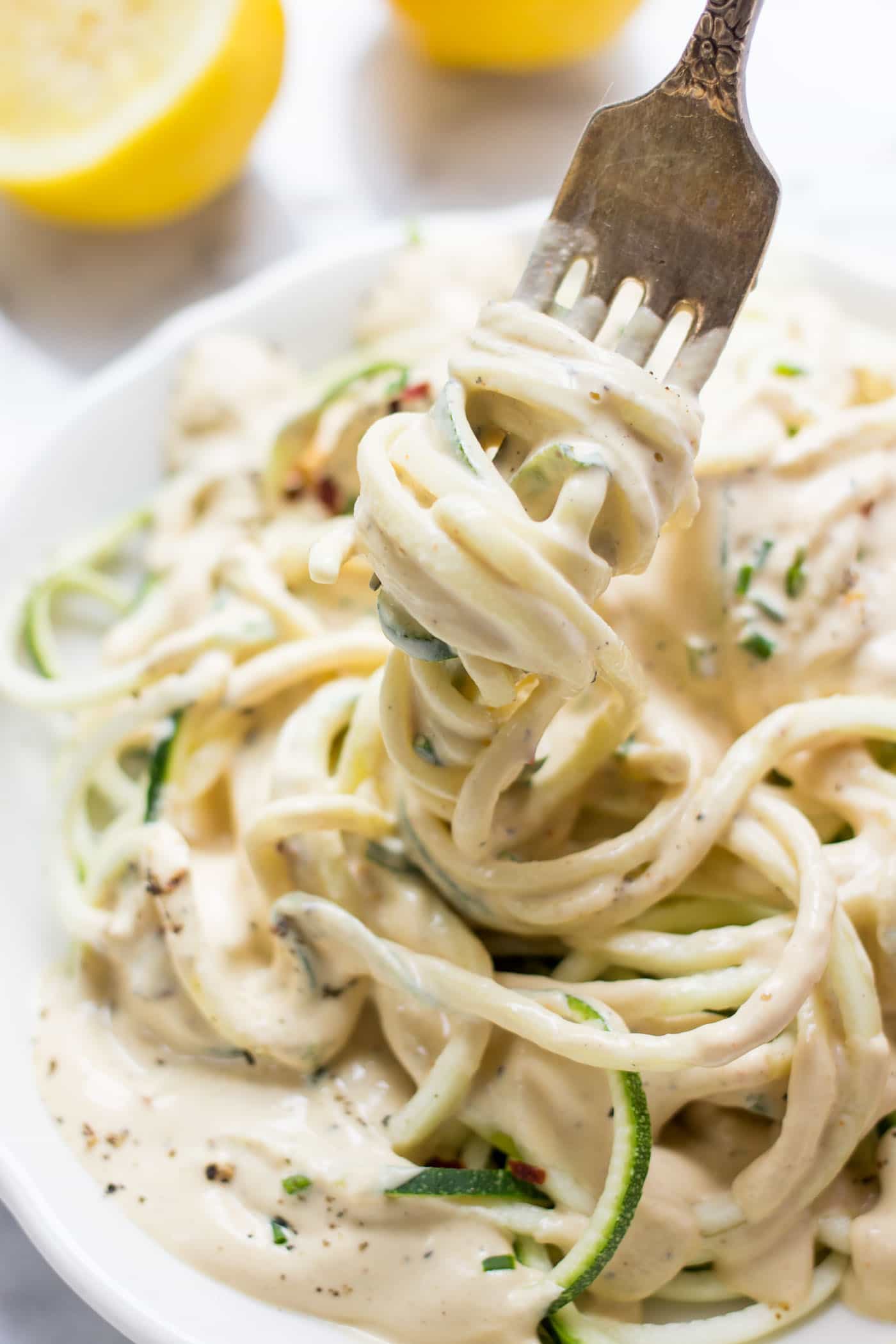 VEGAN LEMON CREAM SAUCE on top of spiralized zucchini noodles! A light and healthy dish that is burst with plant-based protein!