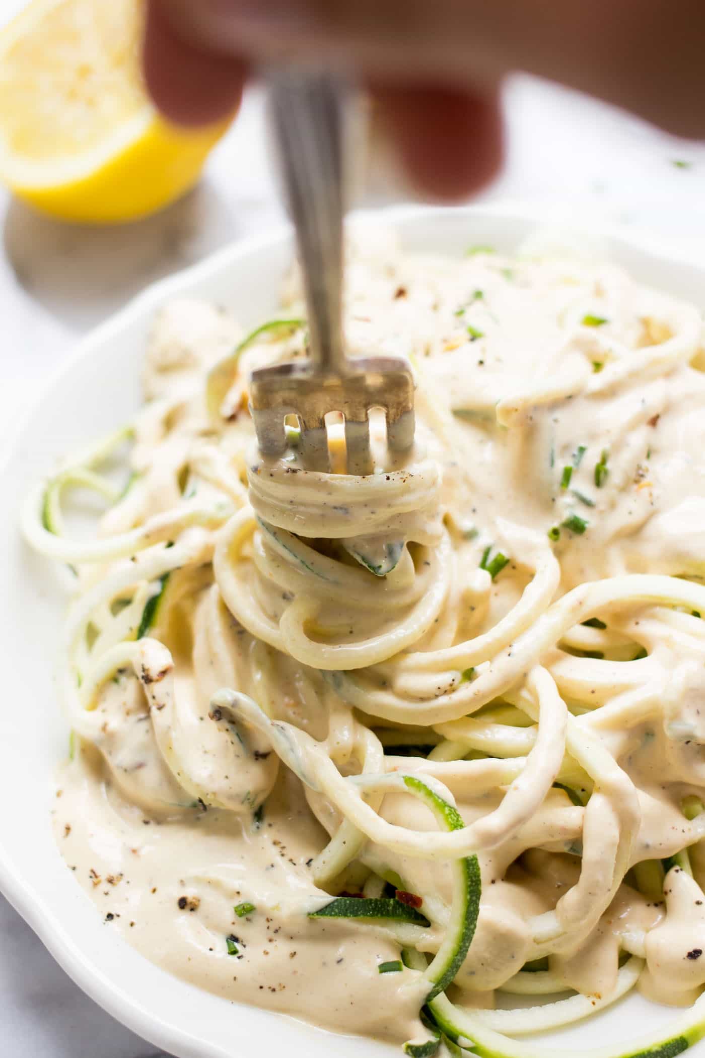 VEGAN LEMON CREAM SAUCE on top of spiralized zucchini noodles! A light and healthy dish that is burst with plant-based protein!