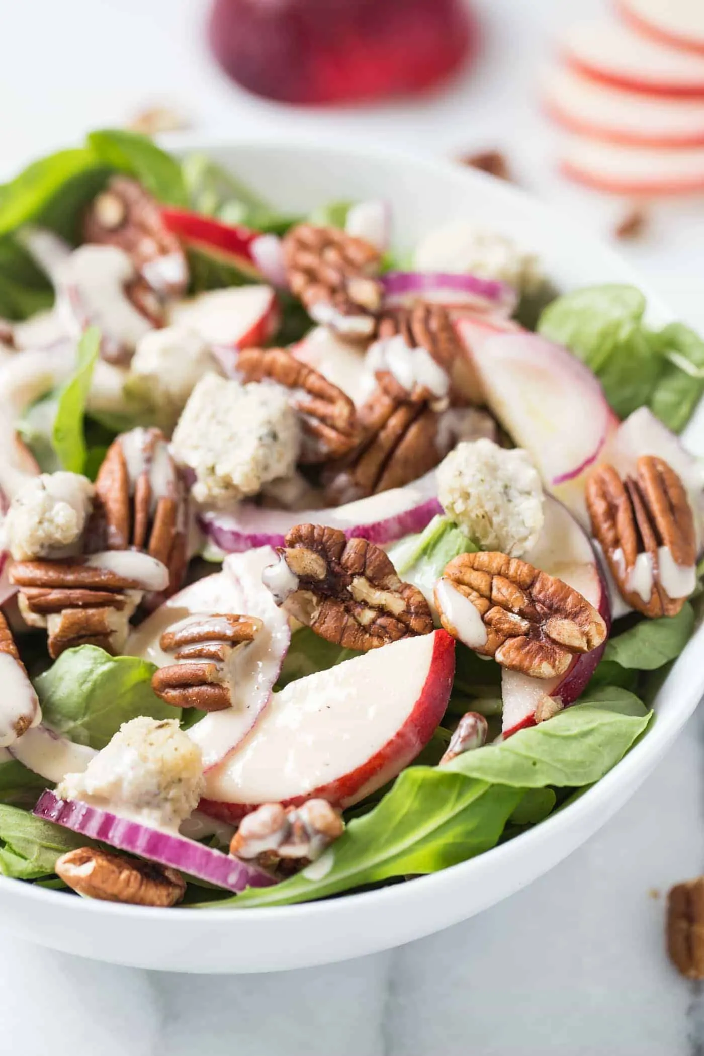 A super simple APPLE + PECAN ARUGULA SALAD topped with herbed cashew cheese and a maple-tahini dressing!