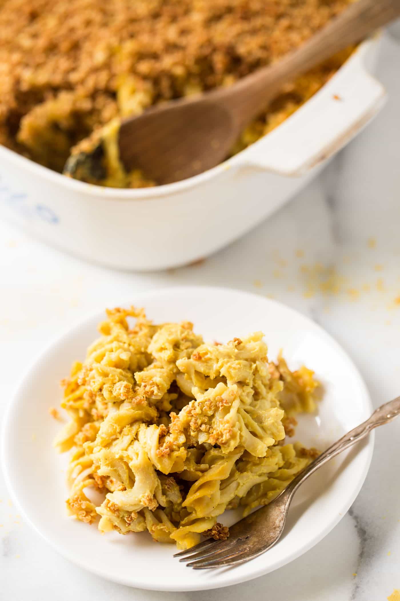 Baked VEGAN Mac and Cheese with a dreamy "cheese" sauce and a crunchy quinoa topping!