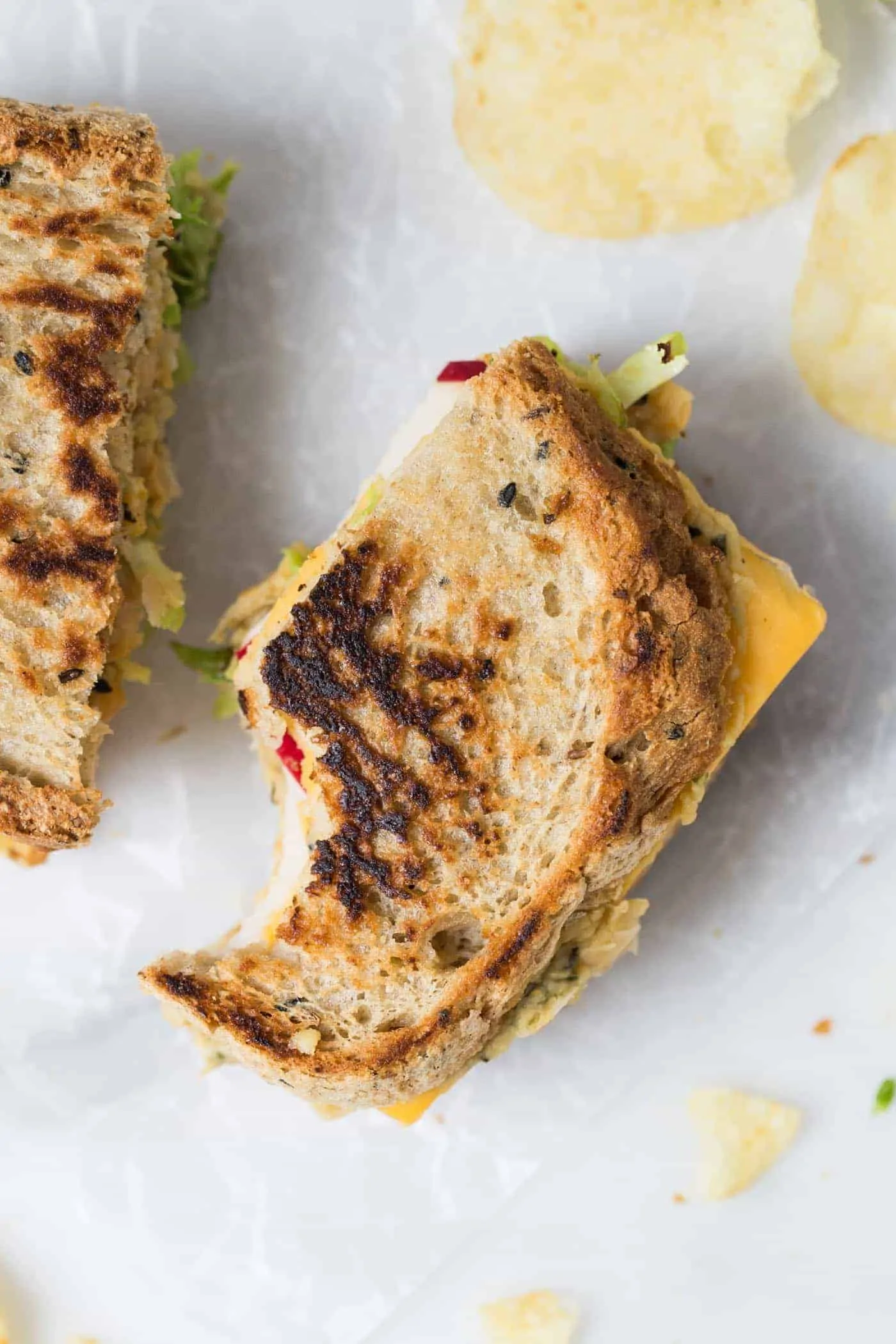 This is hands down THE BEST vegan grilled cheese ever! with brussels sprouts, hummus, apples and more!