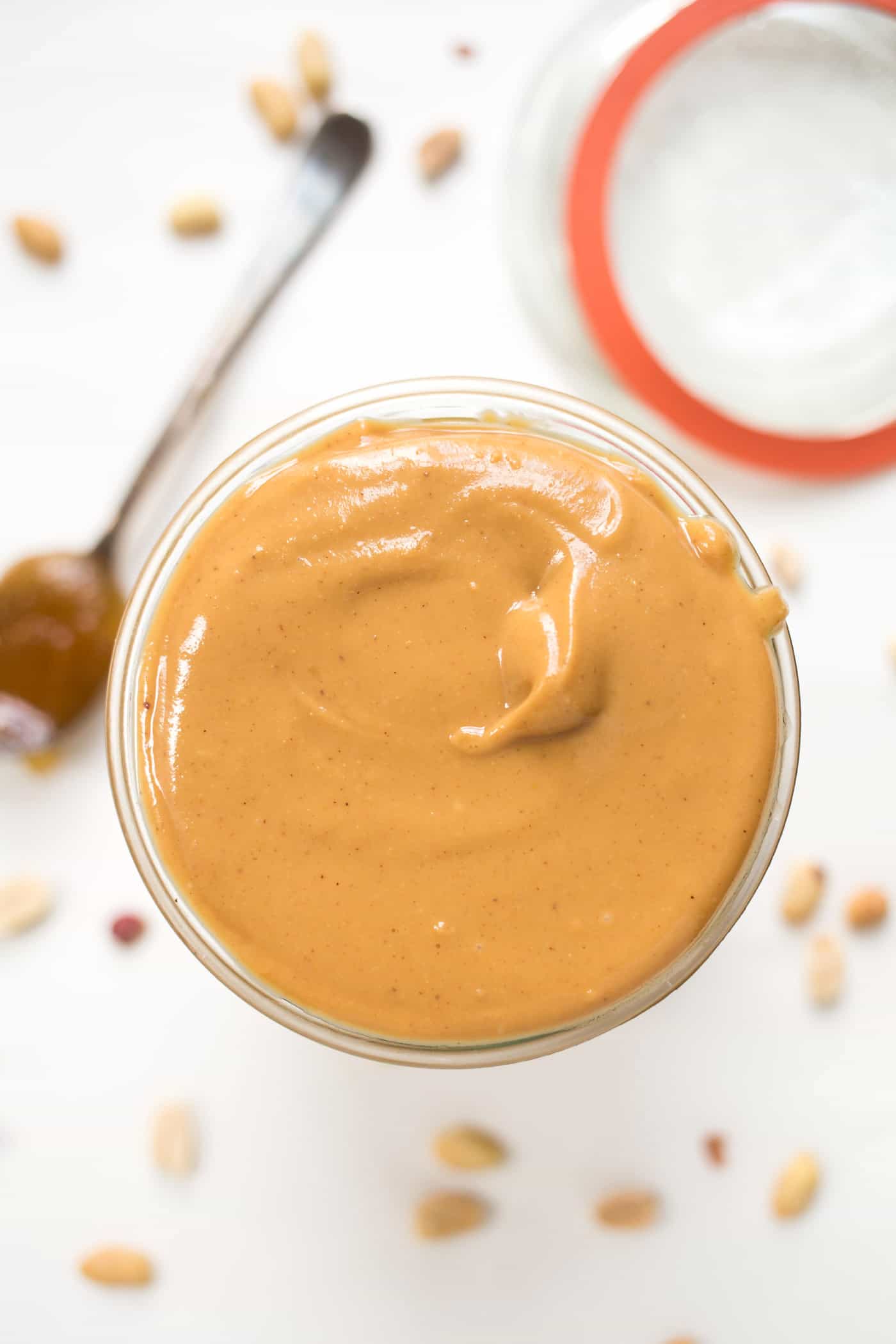 Overhead view of a jar of homemade peanut butter with the lid off