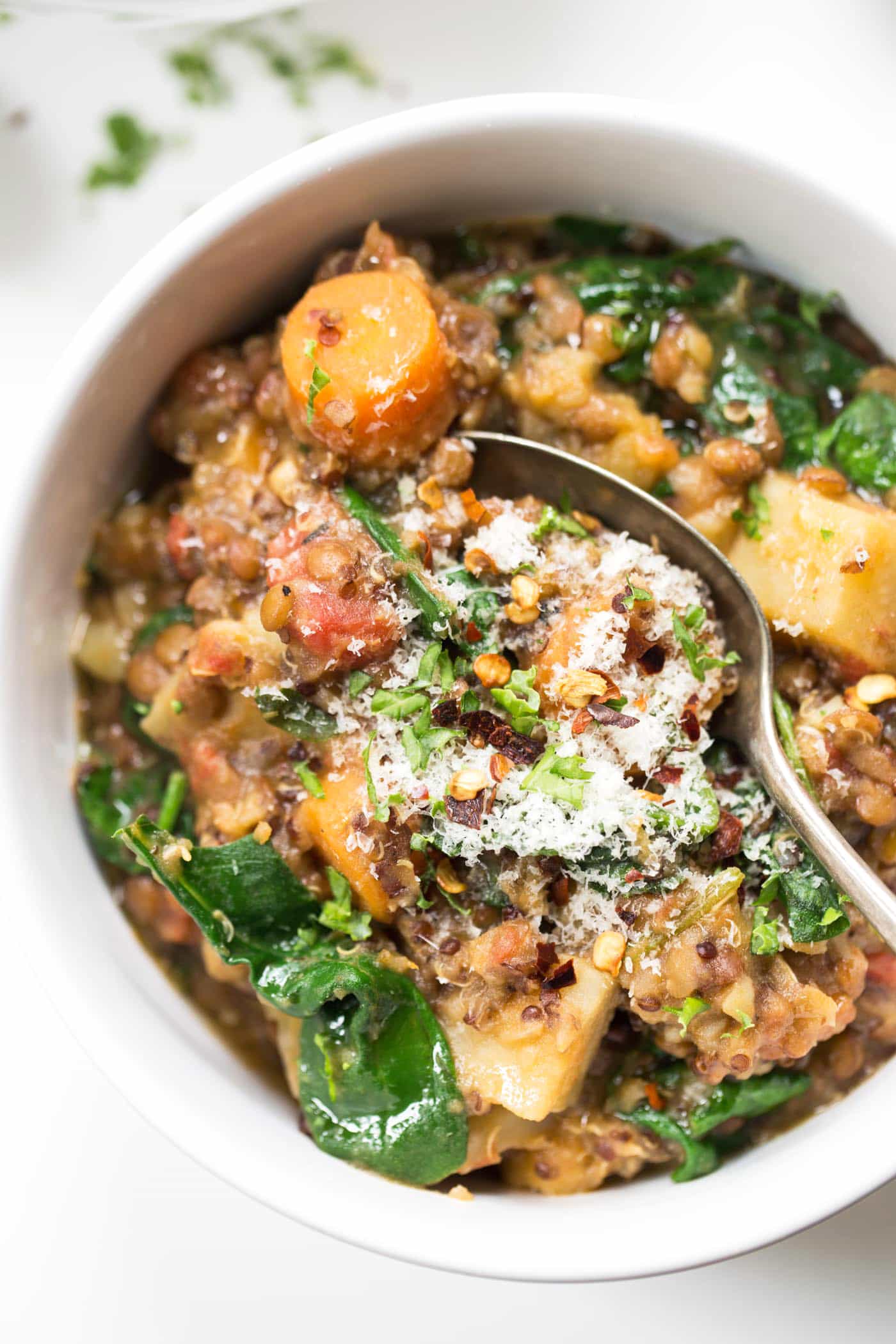 This HEALTHY Lentil Quinoa Stew is packed with root vegetables, tomatoes and spinach for a plant-powered, delicious weeknight meal!