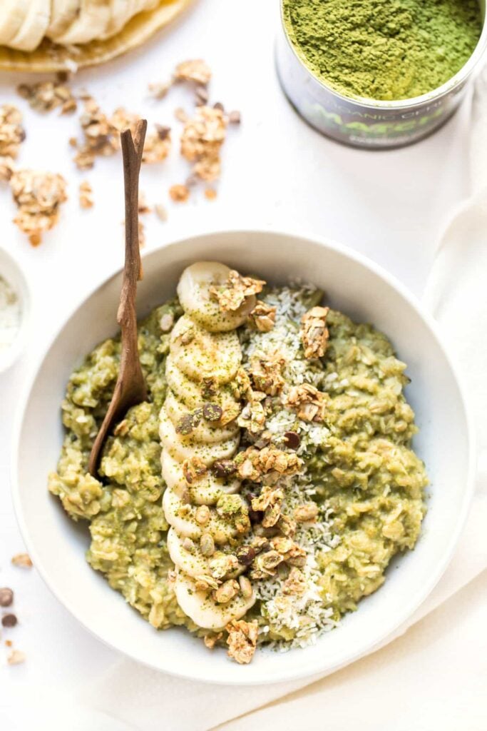 Creamy Coconut Matcha Oatmeal bowls made with three different forms of coconut, topped with banana and granola!