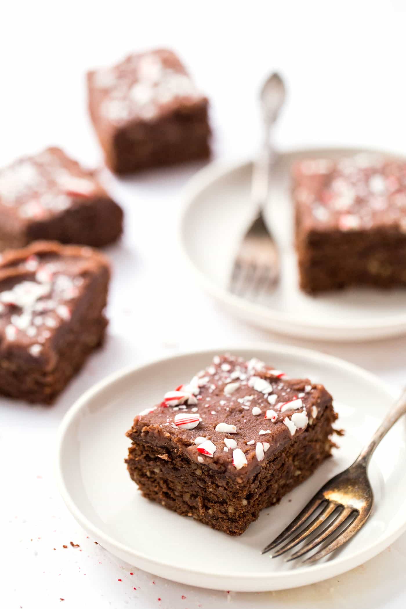 High Protein Chickpea Brownies topped with a chocolate coconut butter icing and crushed peppermint candies! A HEALTHY holiday treat!