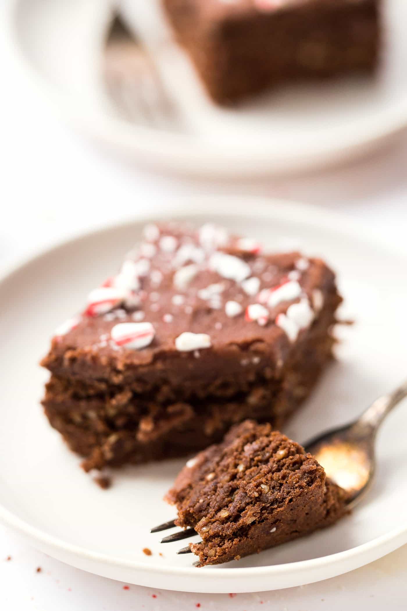 High Protein Chickpea Brownies topped with a chocolate coconut butter icing and crushed peppermint candies! A HEALTHY holiday treat!