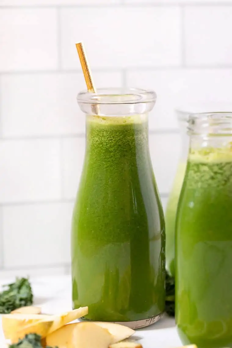 glass of green juice with ginger and lemon