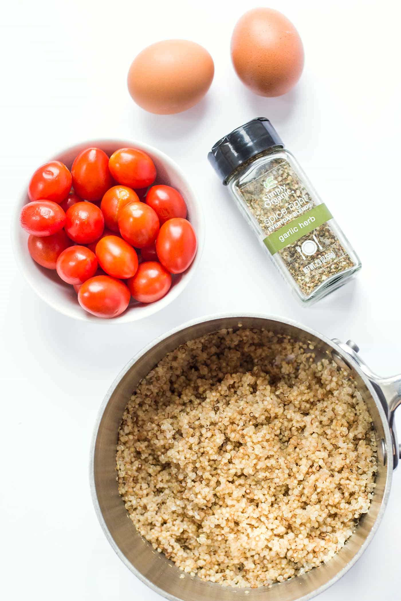 Savory Breakfast Quinoa Bowls with spinach, tomatoes and fried eggs on top!