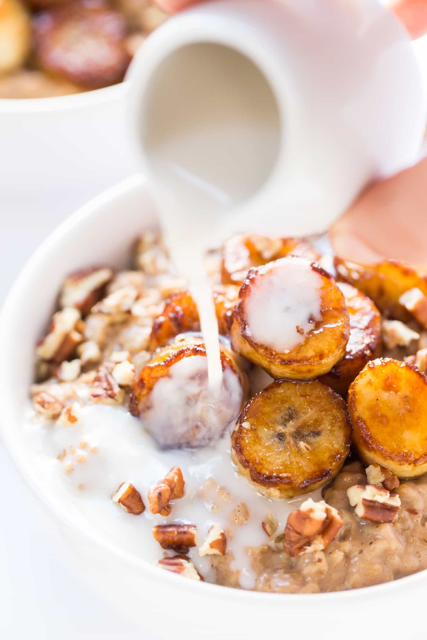 CREAMY STEEL CUT OATS topped with caramelized bananas, pecans and a drizzle of almond milk! [VEGAN]