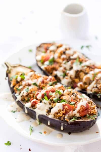 Quinoa Stuffed Eggplant - with mushrooms, tomatoes and a creamy tahini sauce on top! Ready in just 30 MINUTES!