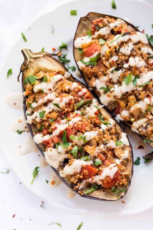 Quinoa Stuffed Eggplant - with mushrooms, tomatoes and a creamy tahini sauce on top! Ready in just 30 MINUTES!
