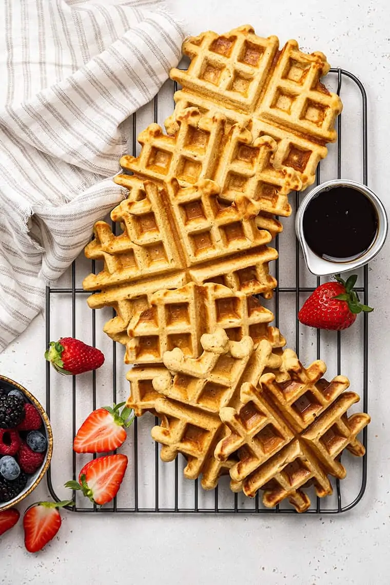 Golden vegan waffles on a cooling rack