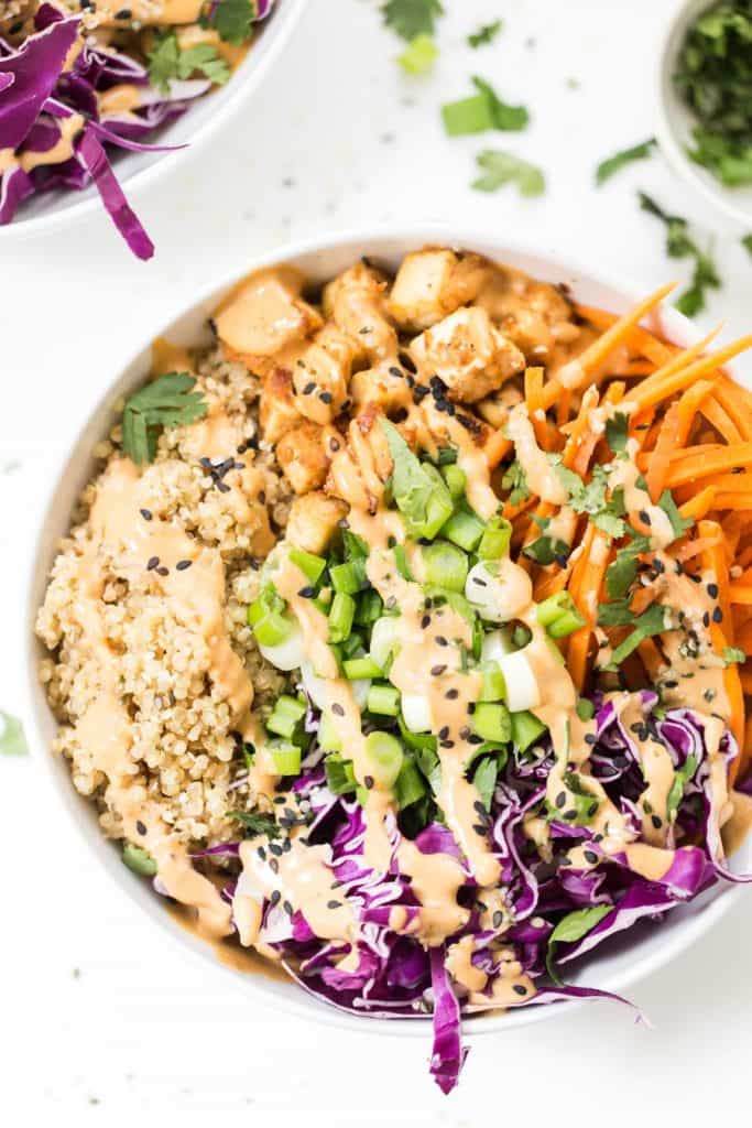 asian quinoa bowls with baked tofu and a creamy peanut sauce