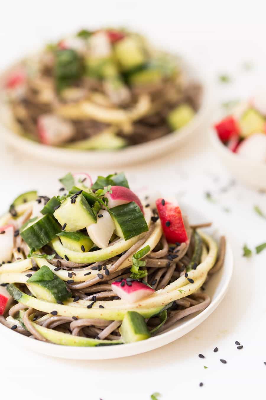 Sesame soba noodles on plate with pickled vegetables