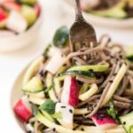 Fork twirling sesame soba noodles on plate